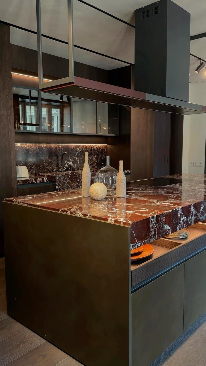 Dark brown marble kitchen island with minimalist decor in a modern neutral kitchen
