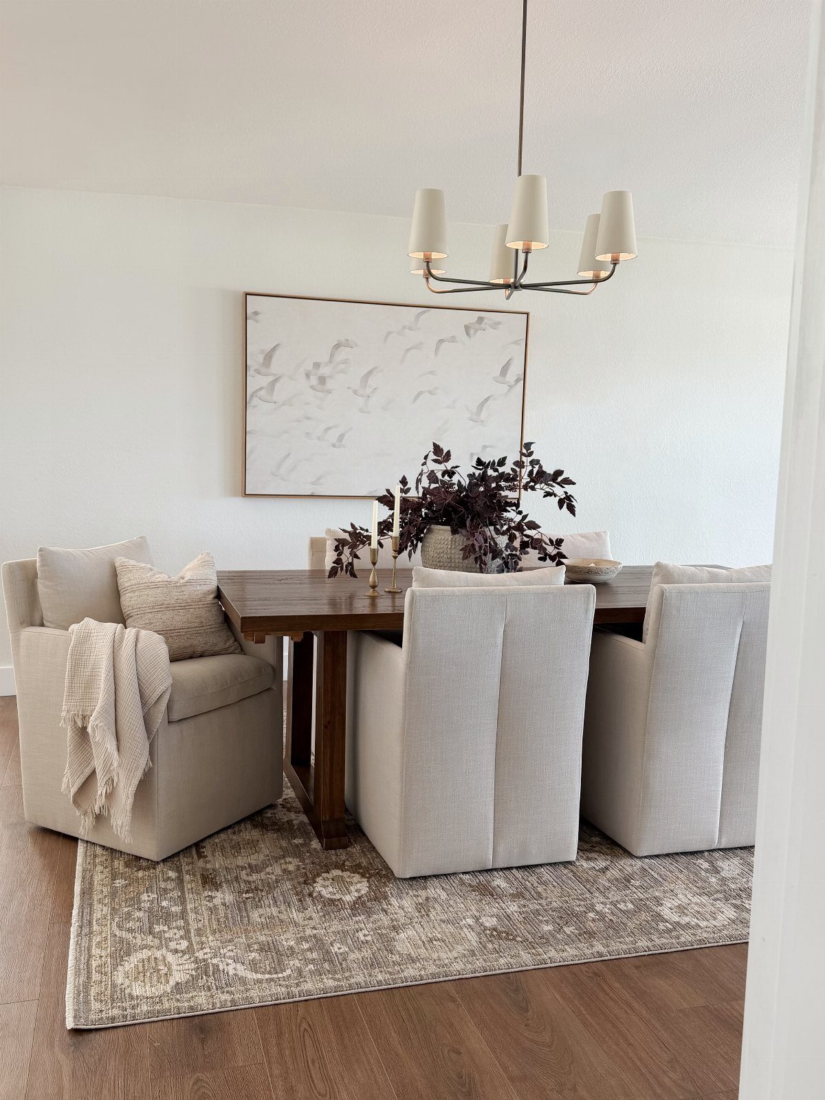 Dining room with a dark wood table and grey patterned area rug.