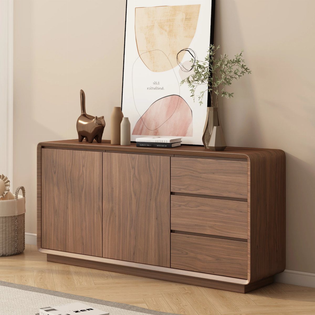 Wooden sideboard with closed cabinets and drawers decorated with art and vases.
