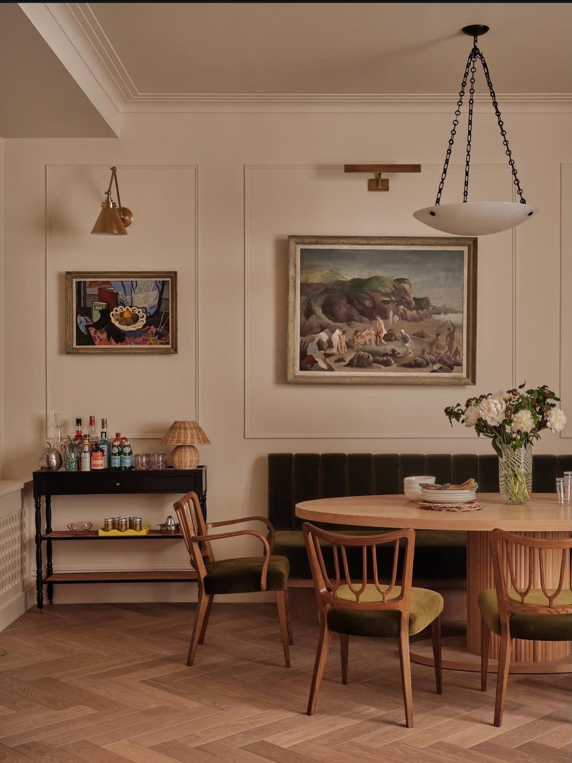 Black sideboard with a framed landscape painting hanging on the wall above it.