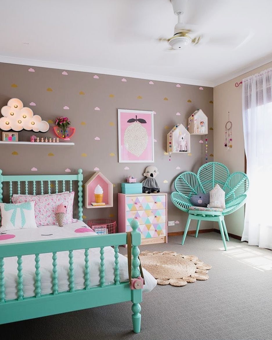 Turquoise bed and leaf-shaped chair in a girl's bedroom with taupe walls.