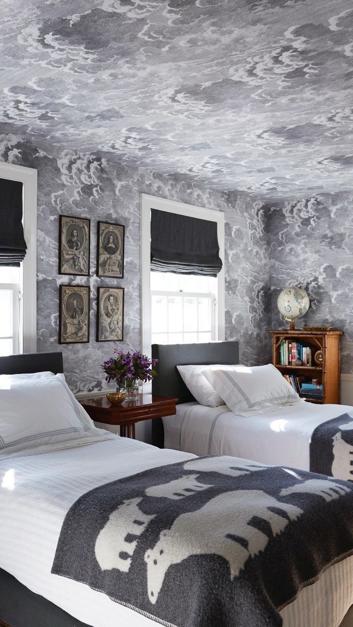 Bedroom with cloud-patterned wallpaper on walls and ceiling and two twin beds.