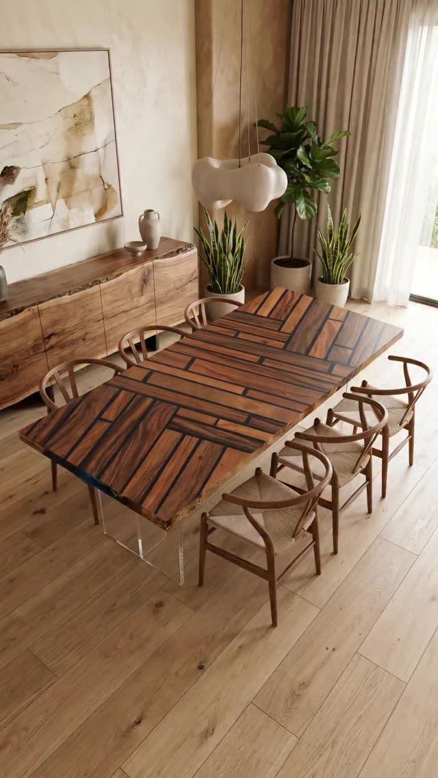 Rectangular wooden dining table with geometric top and clear acrylic legs in modern room.
