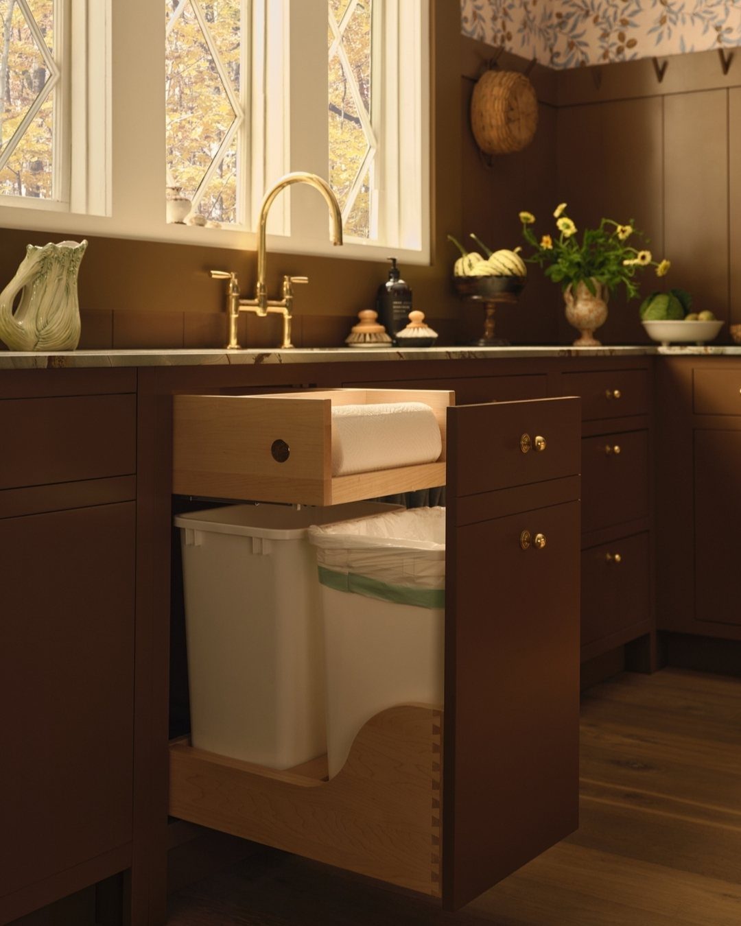 Kitchen paper towel roll stored in a small brown wooden pull-out drawer