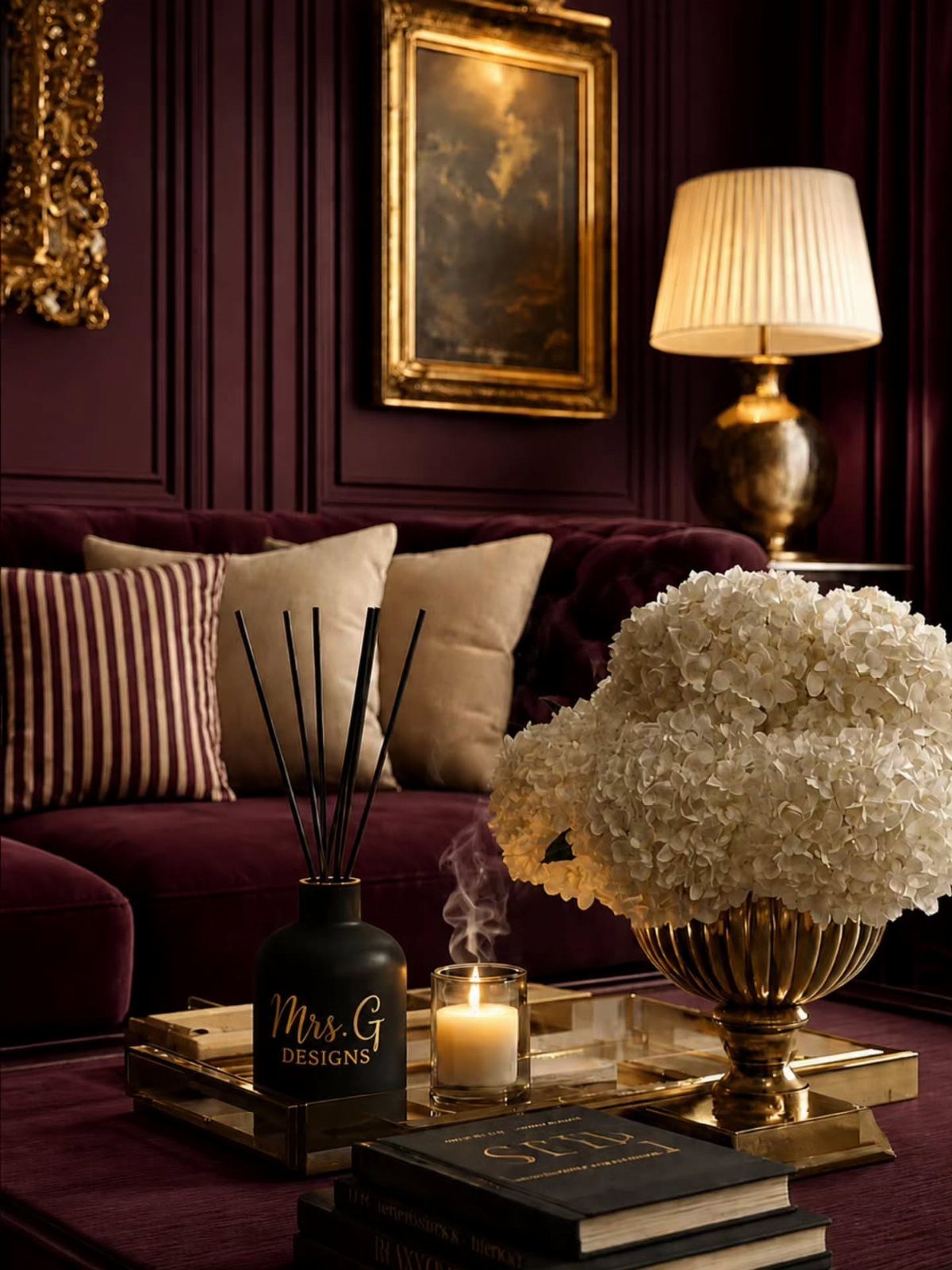 Burgundy velvet sofa and paneled walls with gold frames and decorative gold accents.