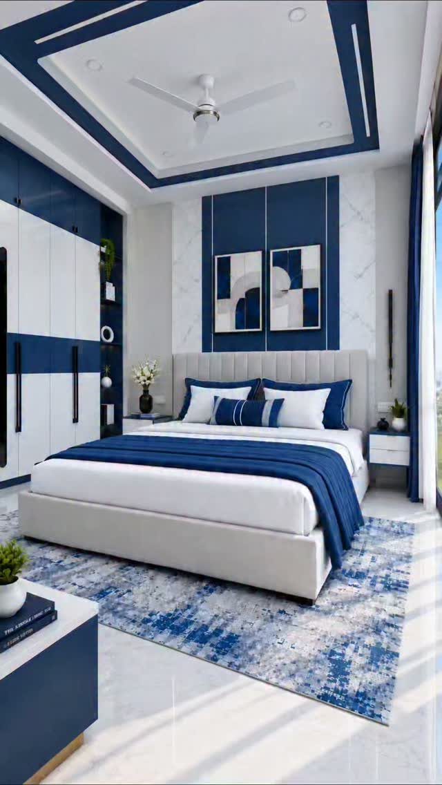 Bed with white bedding and navy throw next to navy blue curtains.