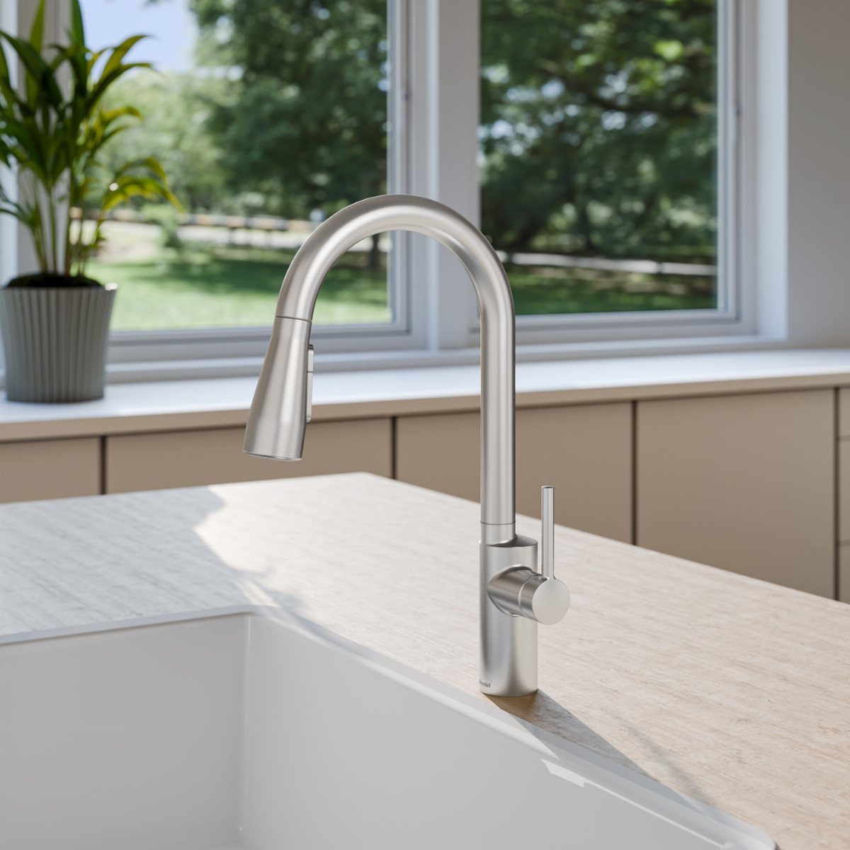 Brushed nickel high-arc kitchen faucet with a single lever handle on a light countertop.