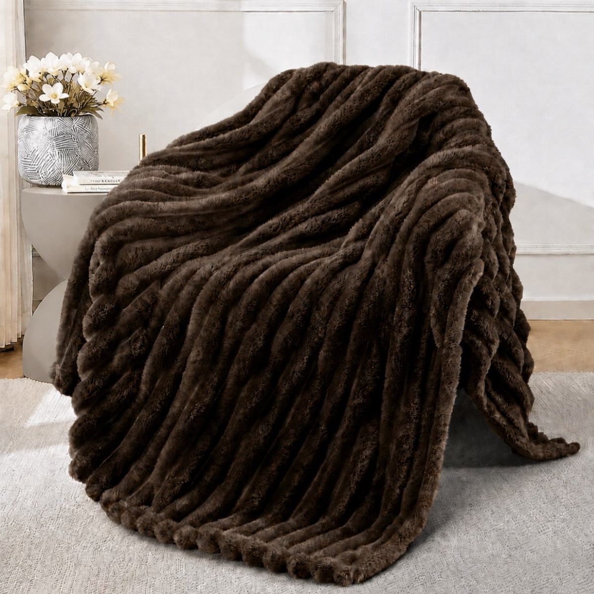 Dark brown faux fur throw blanket draped in a bright, modern room setting.