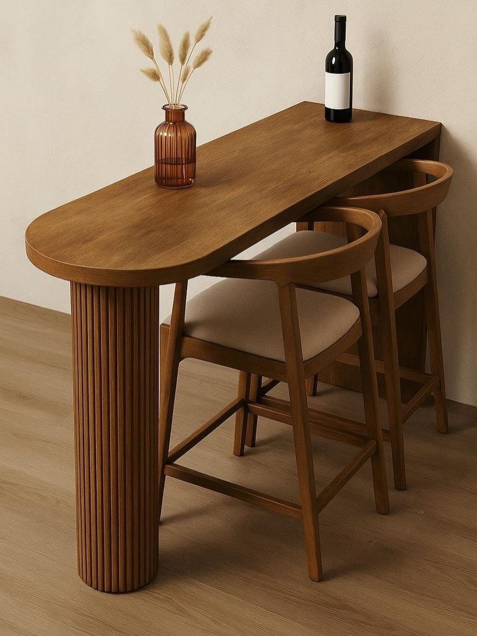 Oval wooden dining table with fluted leg and two matching chairs against a wall.