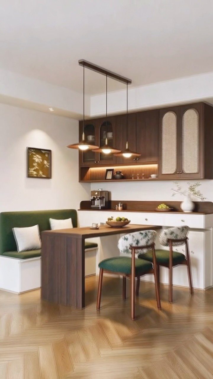 Green upholstered booth seating with a dark wood dining table and matching chairs.