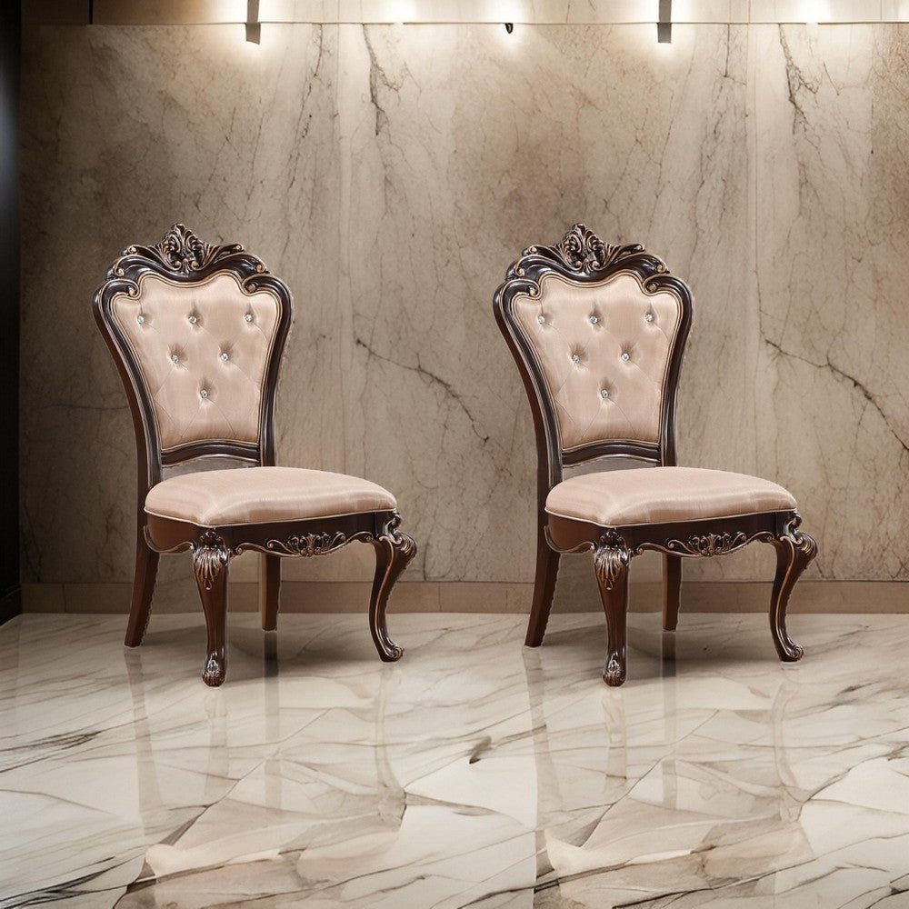Two tan velvet tufted chairs with ornate dark brown carved wooden frames.