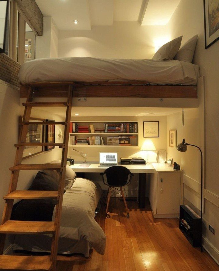 Loft bed with a workspace and desk area underneath in a modern bedroom.