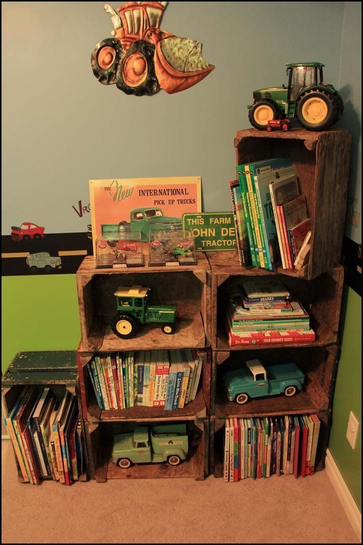Rustic wooden crates used as storage for toy tractors and children's books.