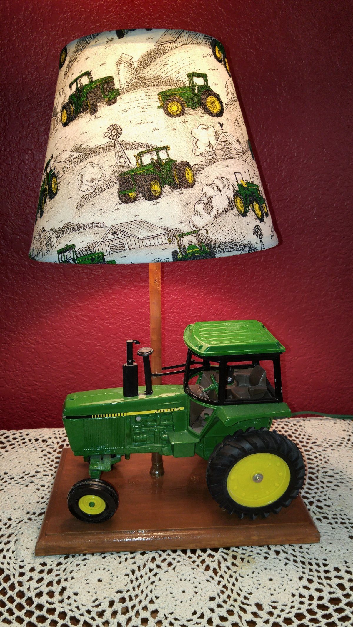 Tractor lamp with a toy tractor base and illustrated tractor lampshade.