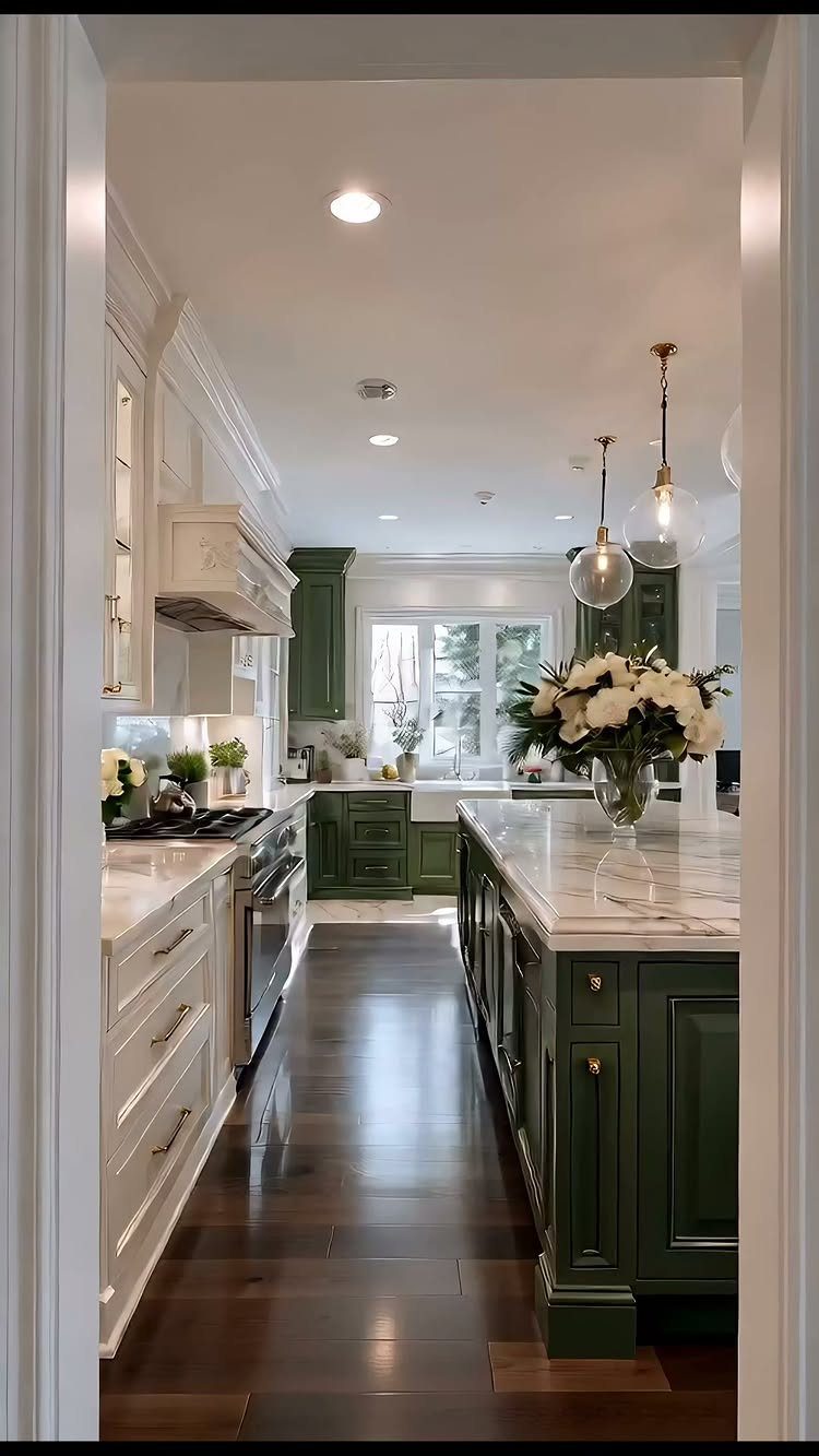 Kitchen with white upper cabinets and sage green lower cabinets and island.