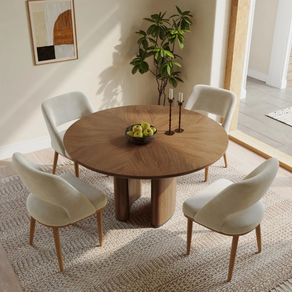 Round walnut dining table with a sculptural pedestal base and cream upholstered chairs.